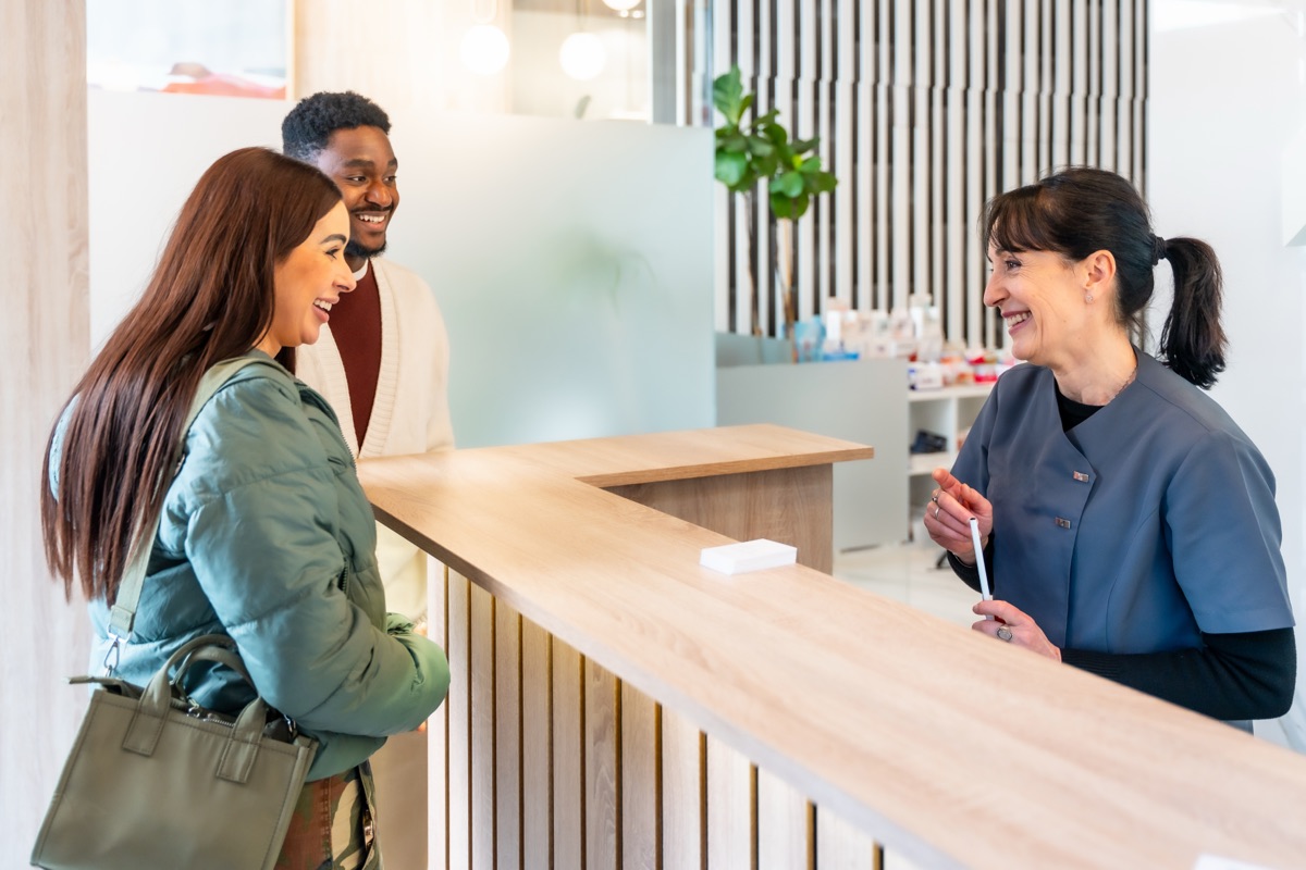 Patient checking in smoothly at a modern clinic front desk